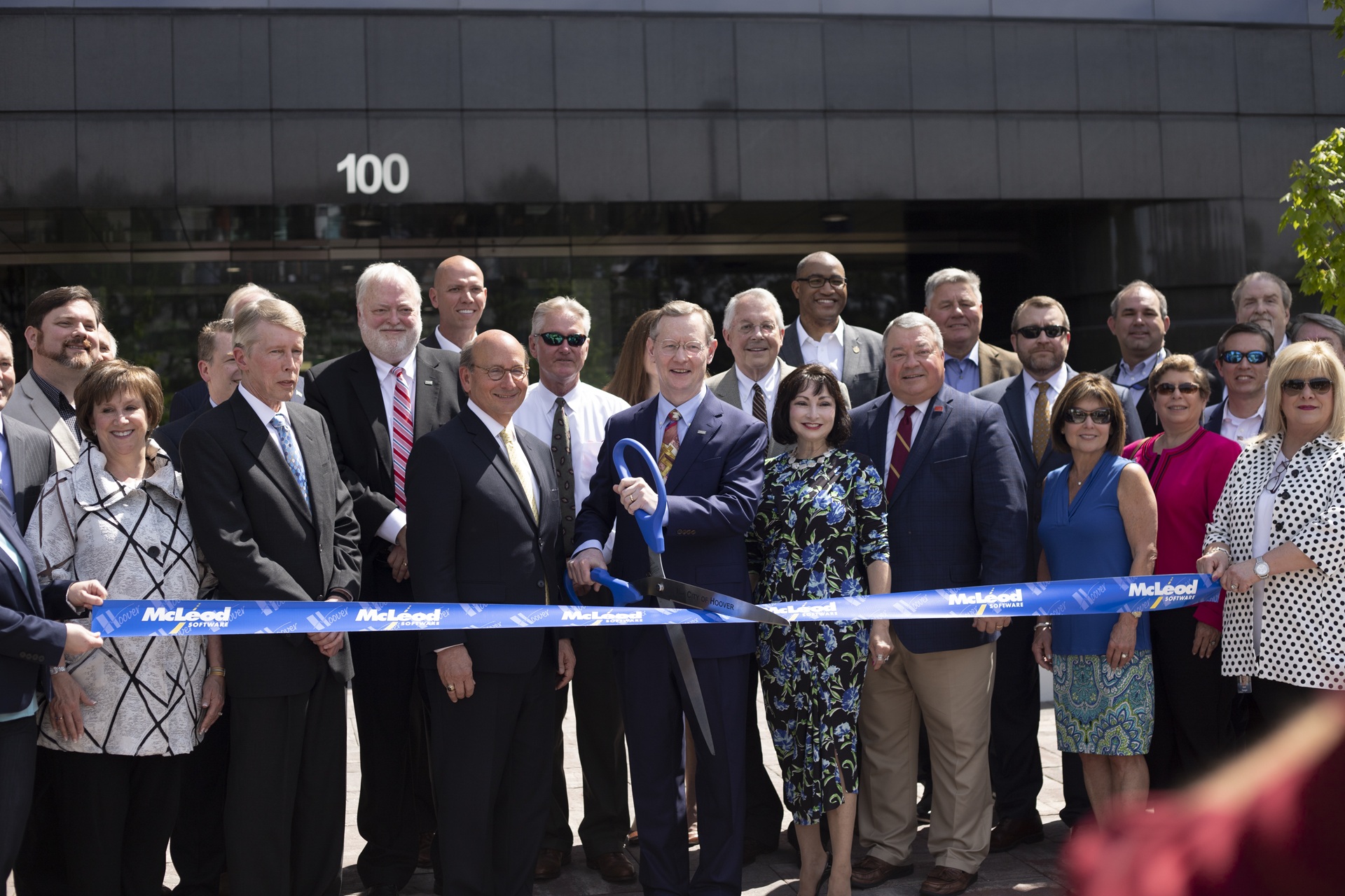 Tom and Annette McLeod with company leaders and public officials at the 2019 headquarters ribbon cutting