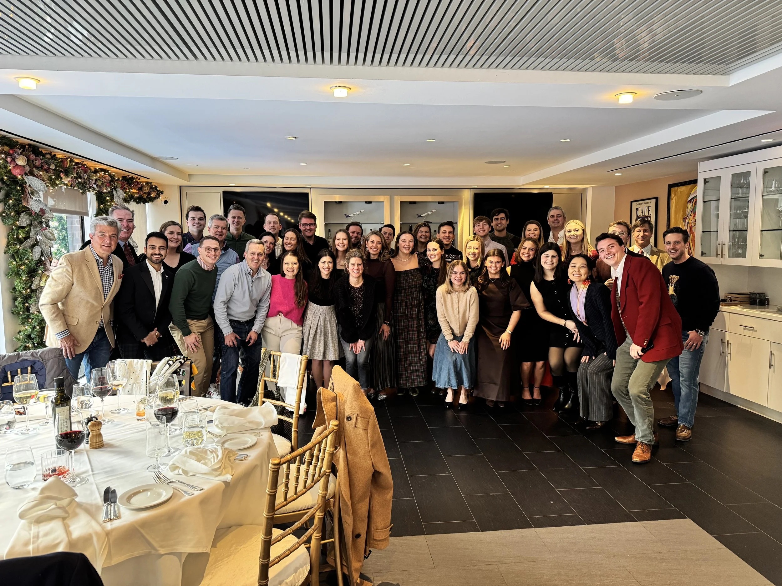 The Herald Group team gathered together in a dining room