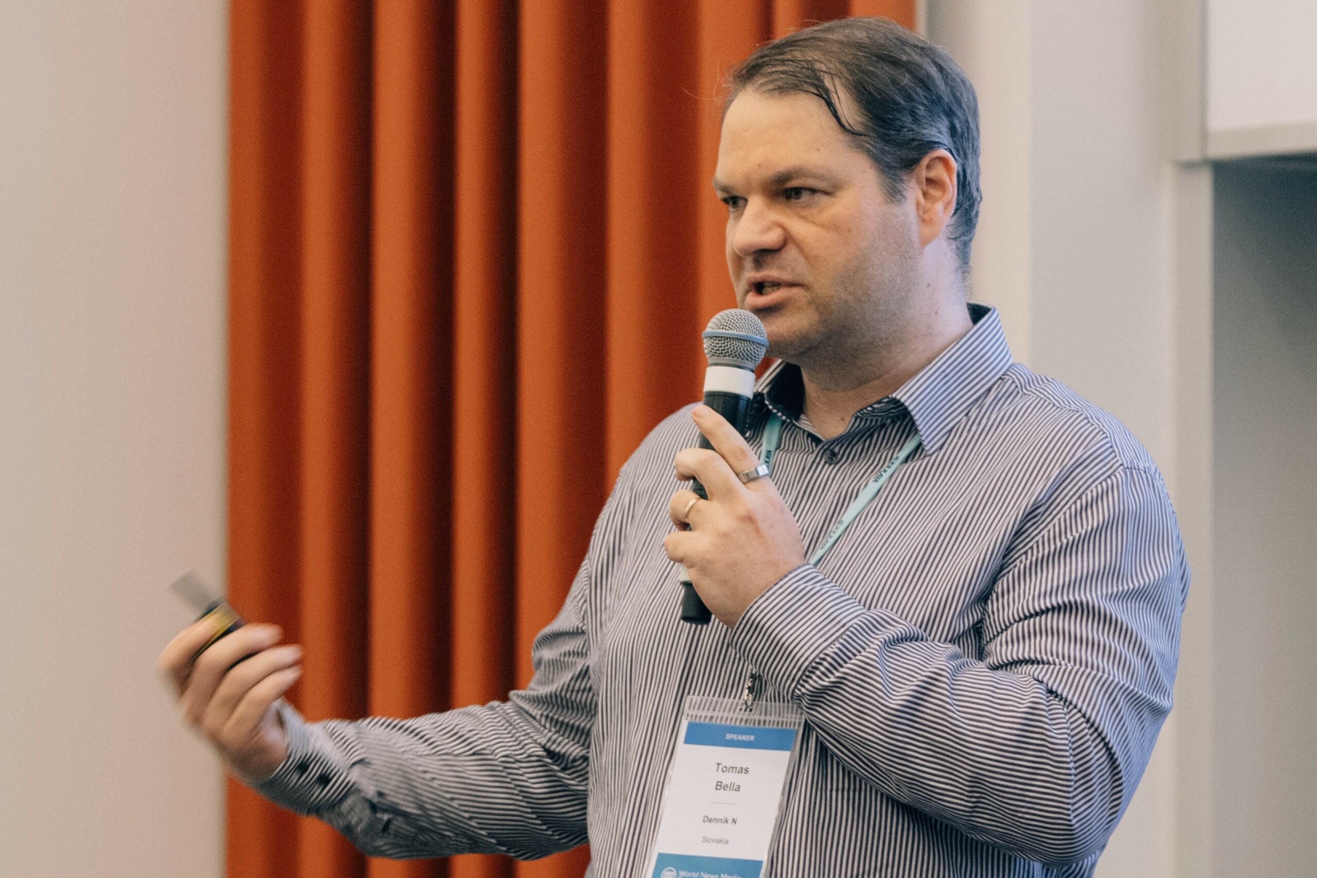 Tomáš Bella speaking into a microphone at the World News Media Congress in Copenhagen