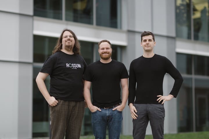 Rossum co-founders Petr Baudiš, Tomáš Gogár and Tomáš Tunys standing outside an office building