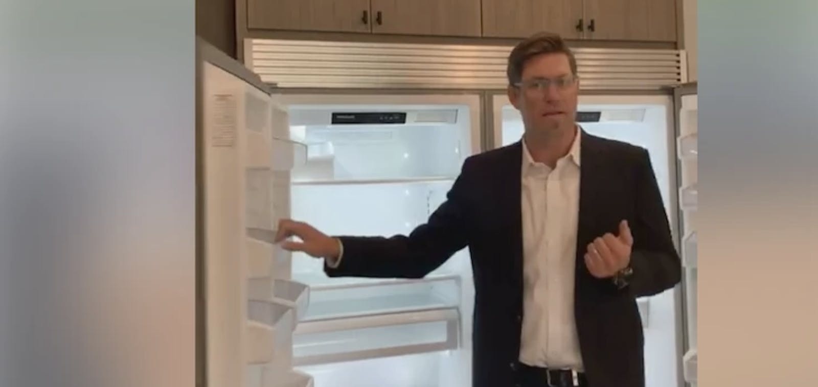 Tommy Beadel opens a refrigerator during a virtual tour of a Trademark by TJH home
