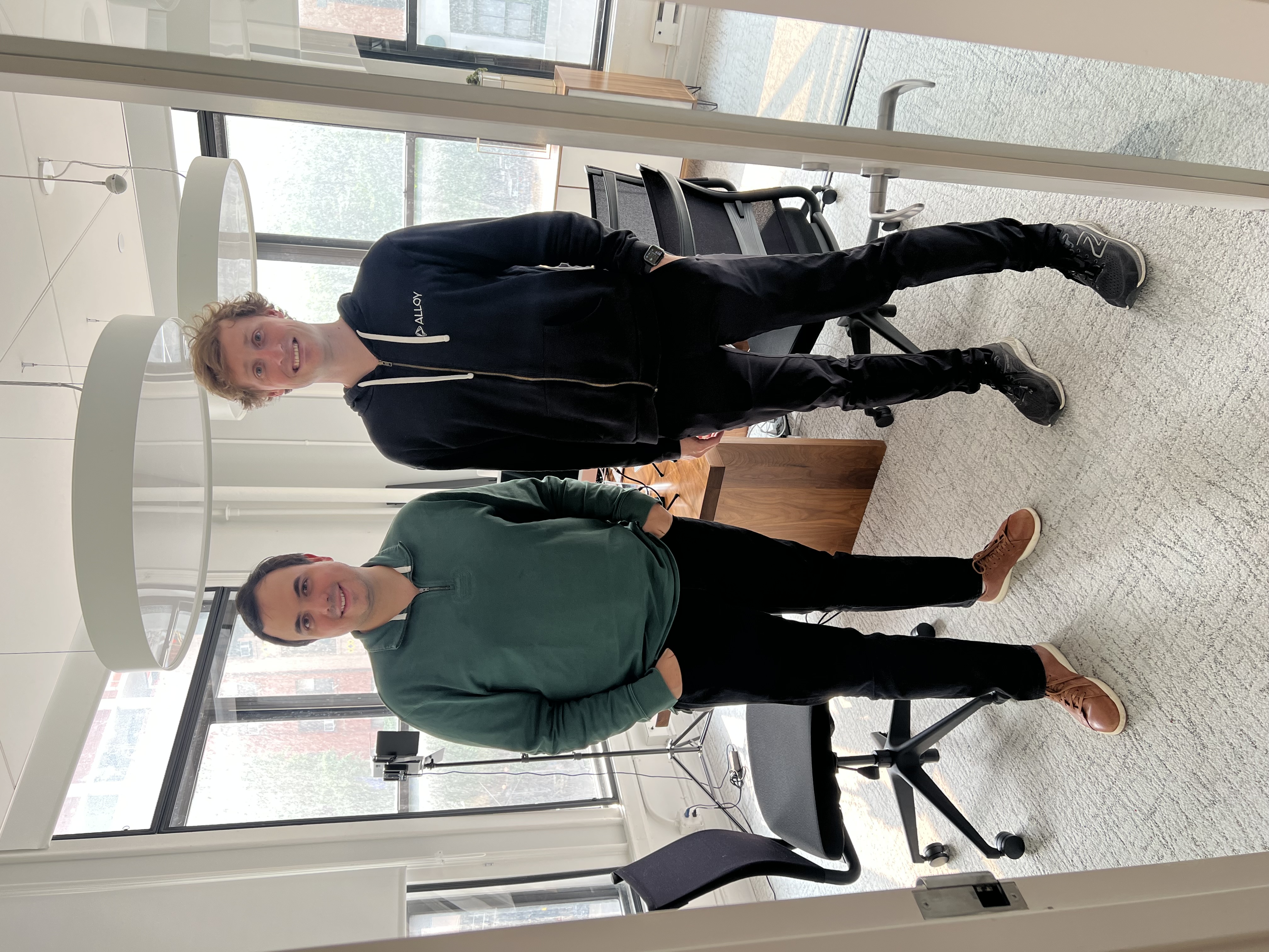 Miguel Armaza, left, and Tommy Nicholas, right, standing in an Alloy office meeting room