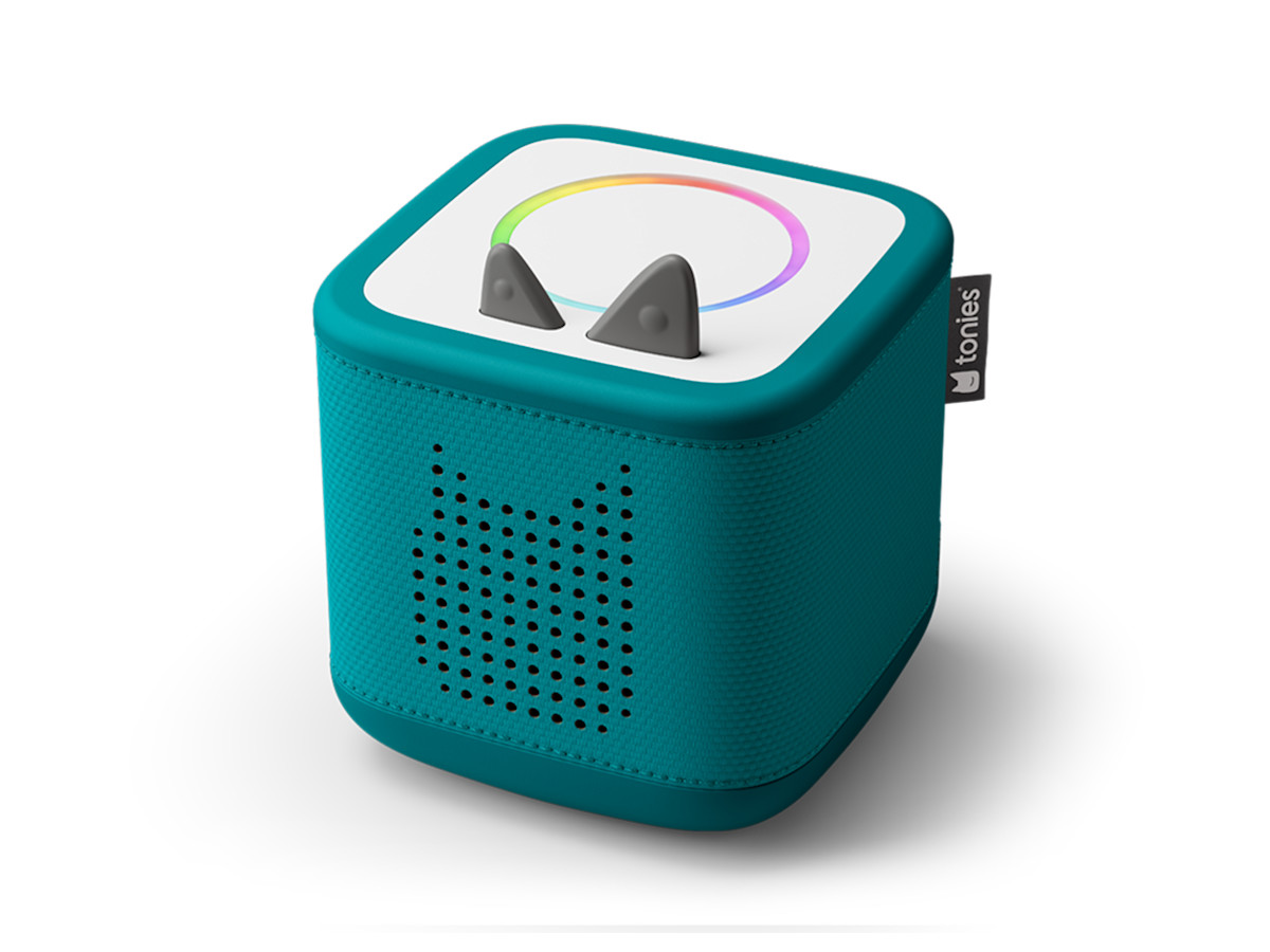 A tropical teal Toniebox 2 with a figurine standing on top