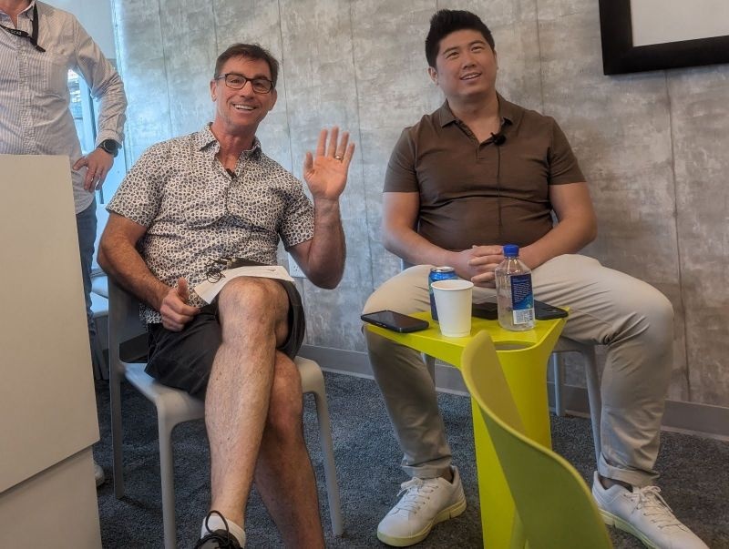 Tony Chen seated on the right during a conversation at Google, with a yellow table between the participants