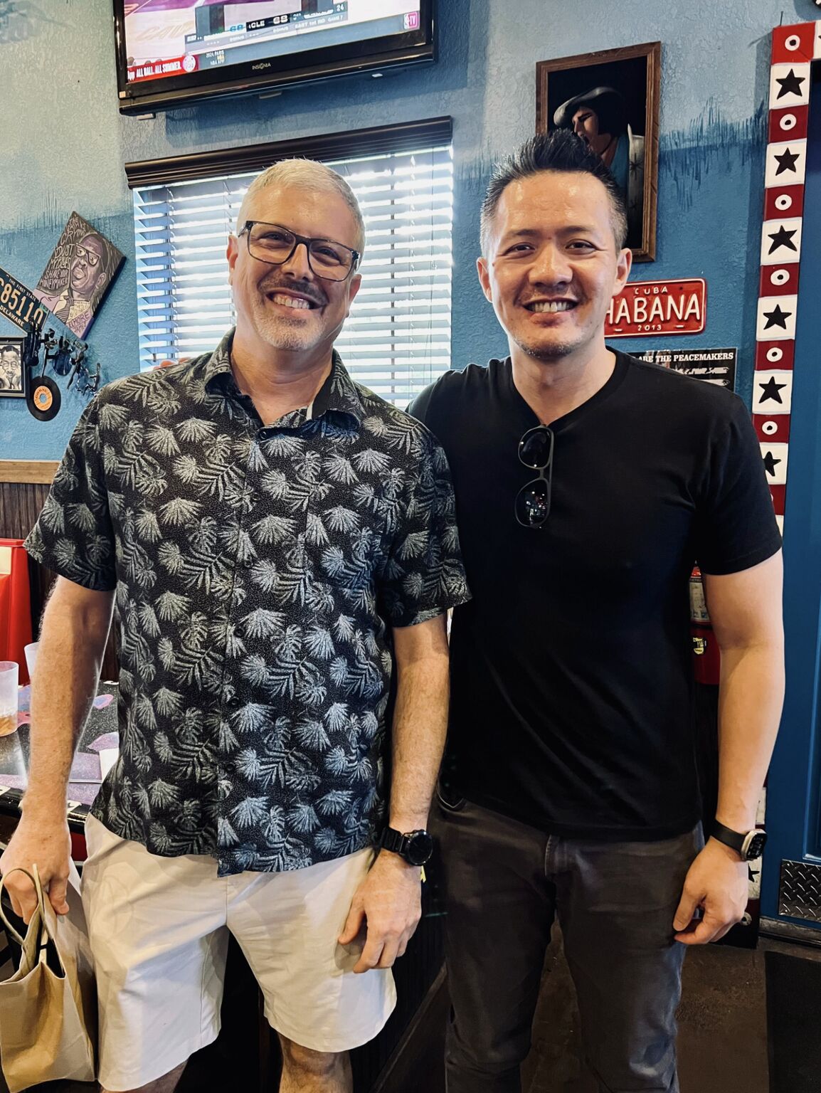 Bob Pascucci, left, and Tony Huie smiling together in a restaurant in Florida