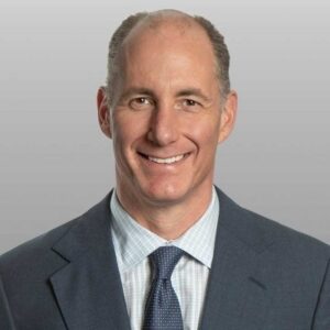 Tony Minella in a suit and tie in a press portrait