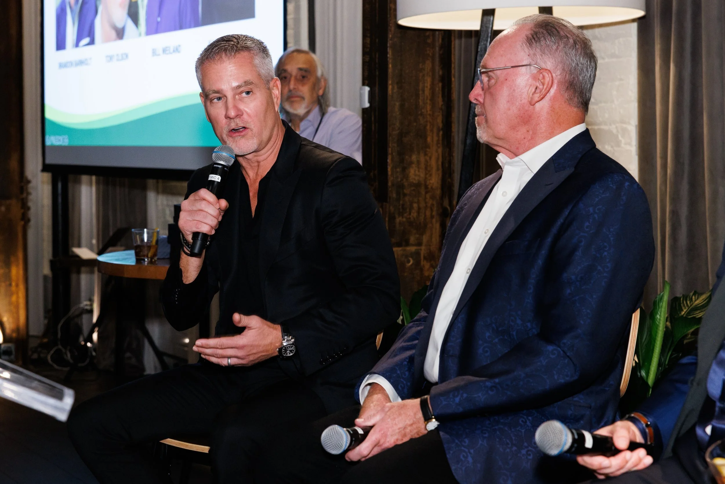 Tony Olson holding a microphone during Naturally Chicago’s Founders’ Gala