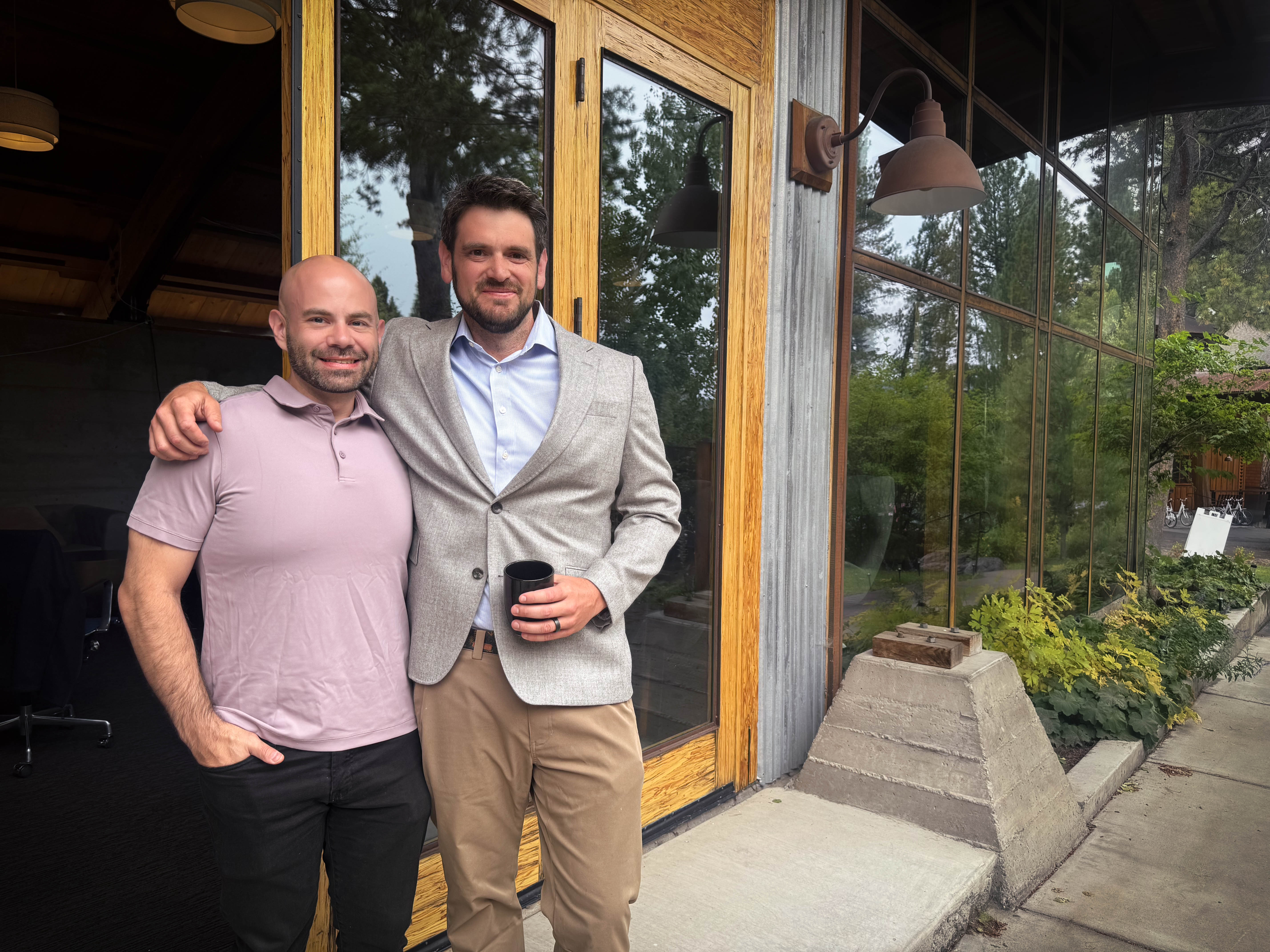 Yeti co-founders Rudy Mutter and Tony Scherba standing together outside a building