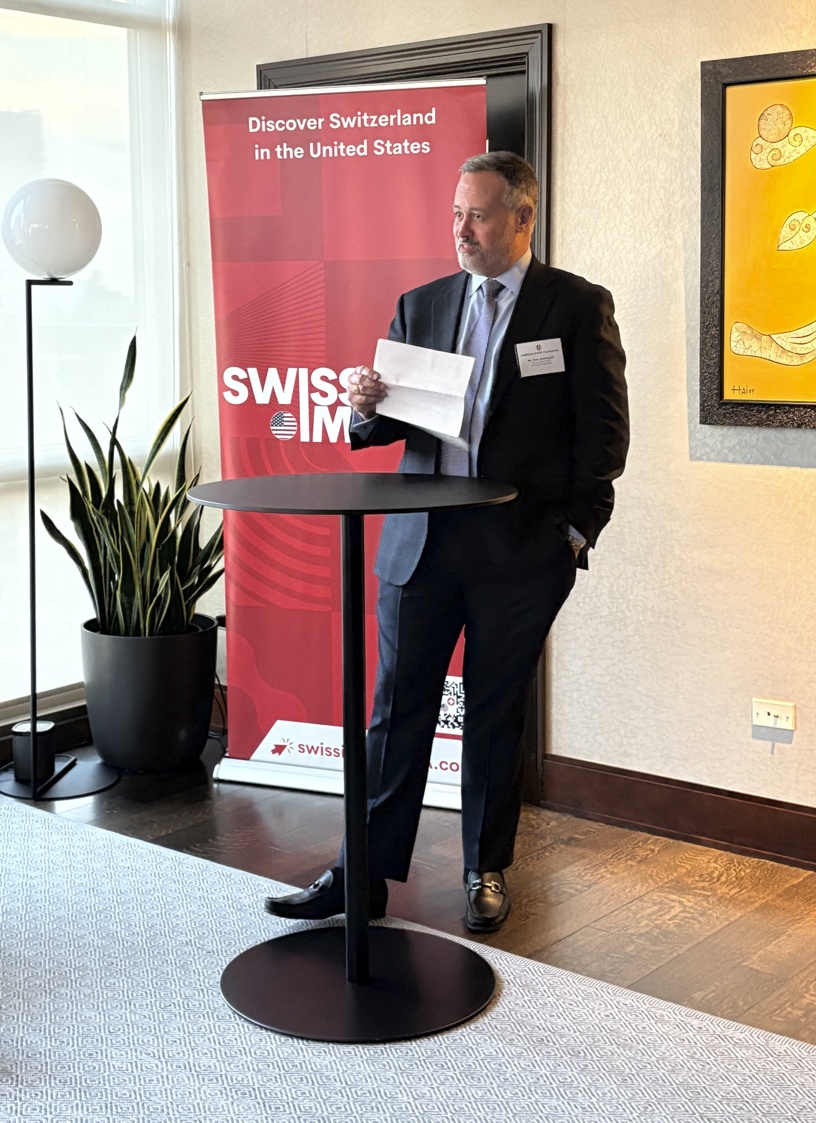 Tony Svanascini speaking with notes at an American Swiss Foundation gathering in Chicago