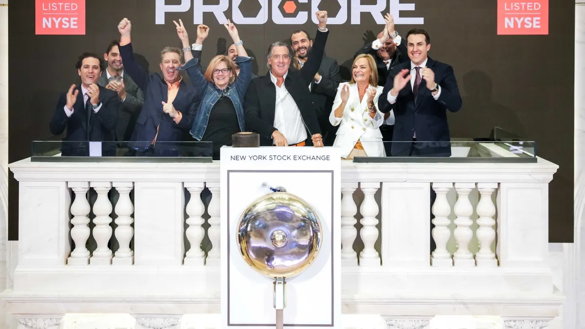 Courtemanche and a group celebrating at the New York Stock Exchange podium during Procore's public debut.
