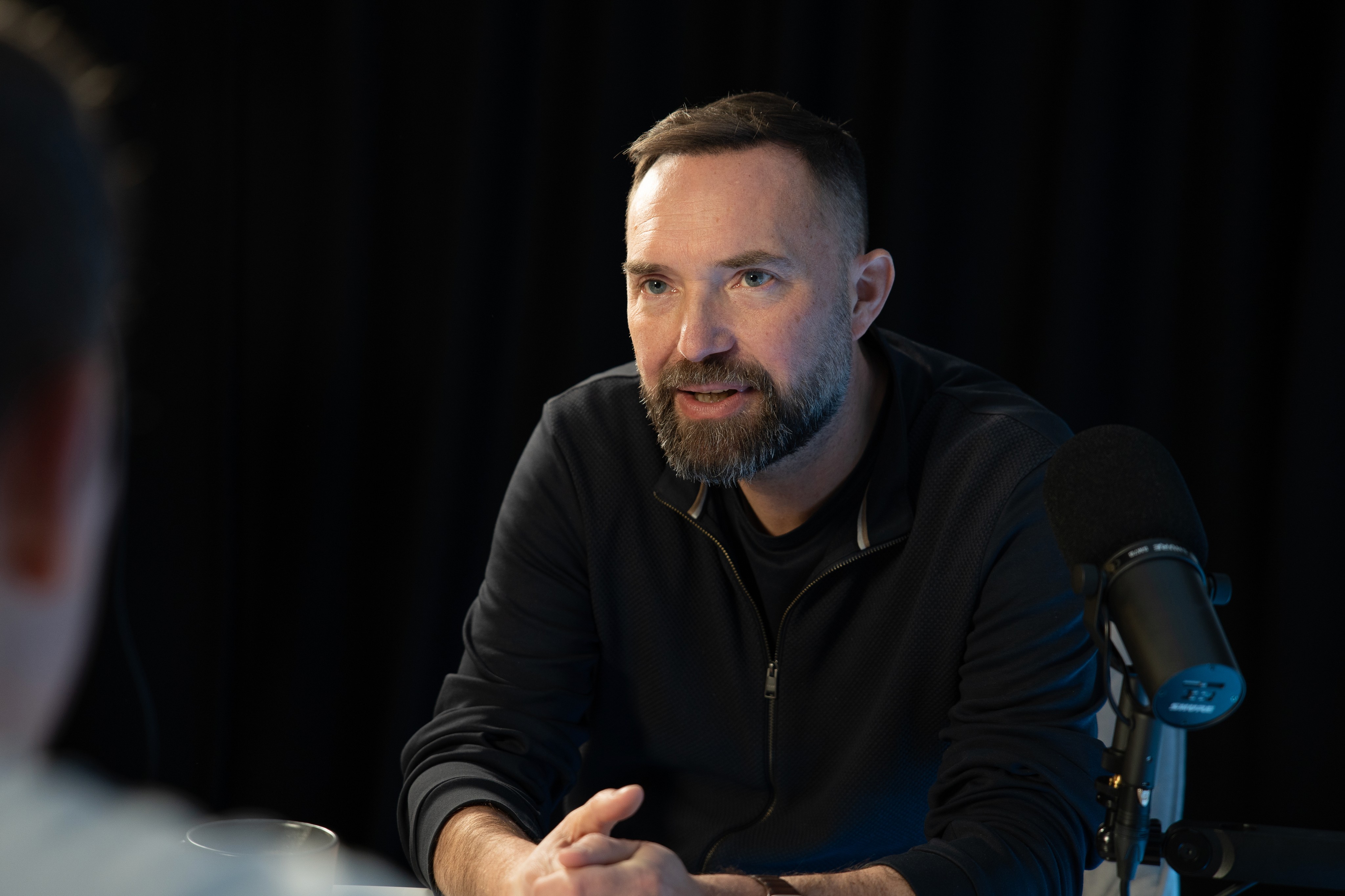 Torsten Reil speaking in a podcast studio