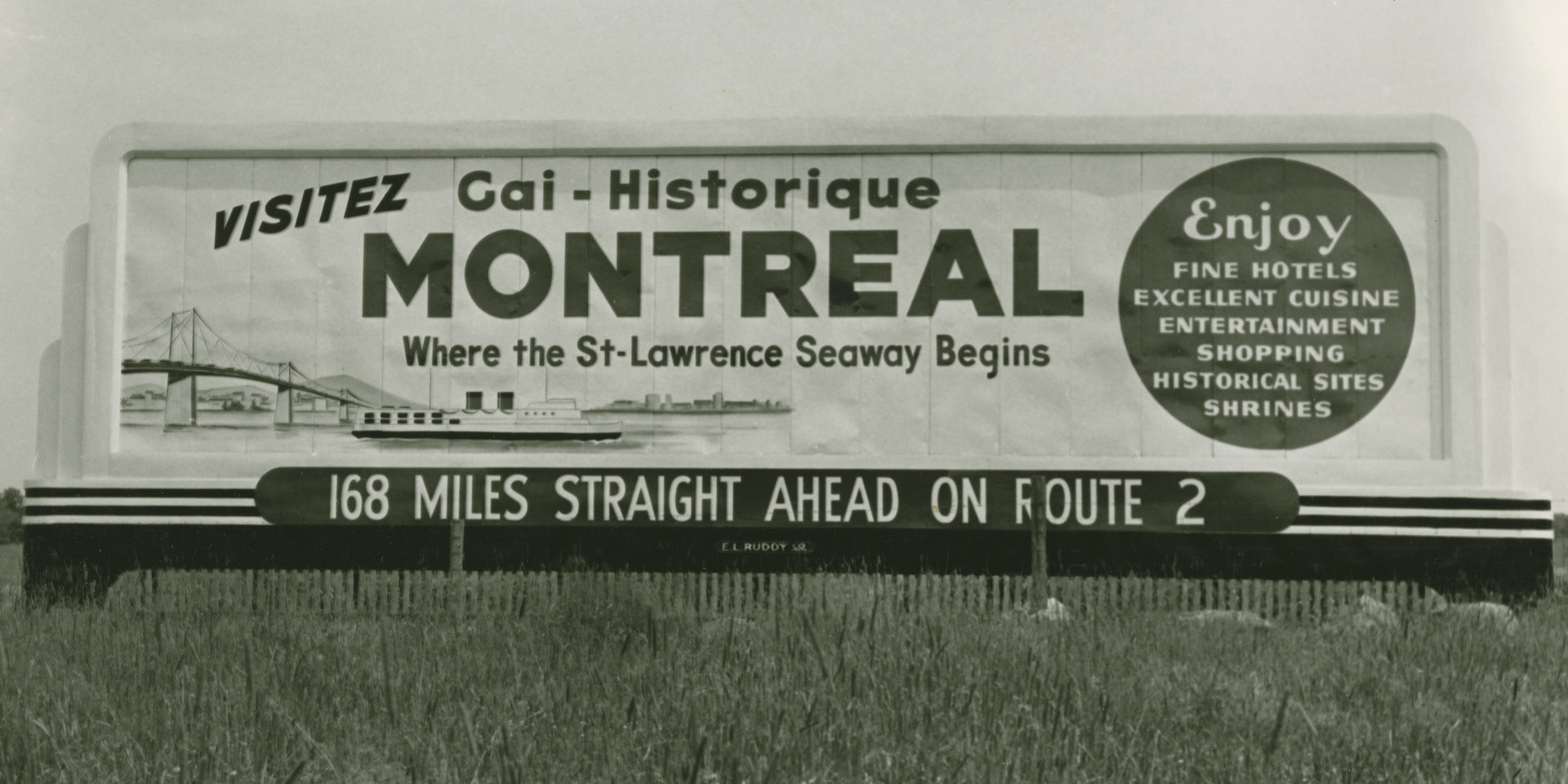Historic roadside billboard promoting Montréal, with a ship, bridge and a list of city attractions