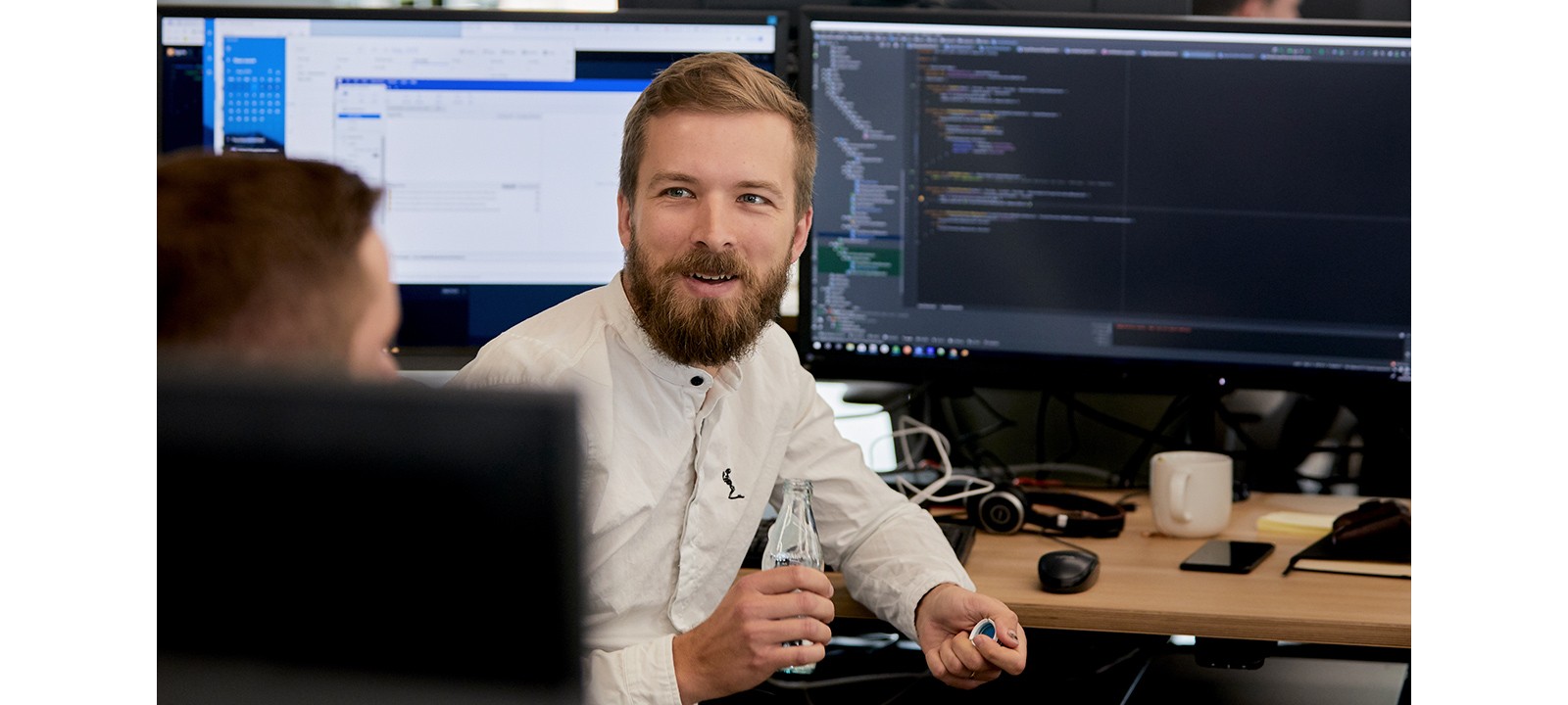 Toyota Connected Europe developers discussing work in an office