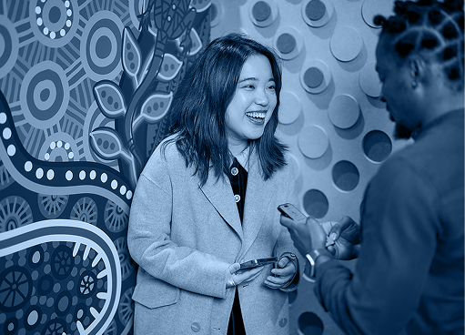 Two people talking in a TPG Telecom careers photograph