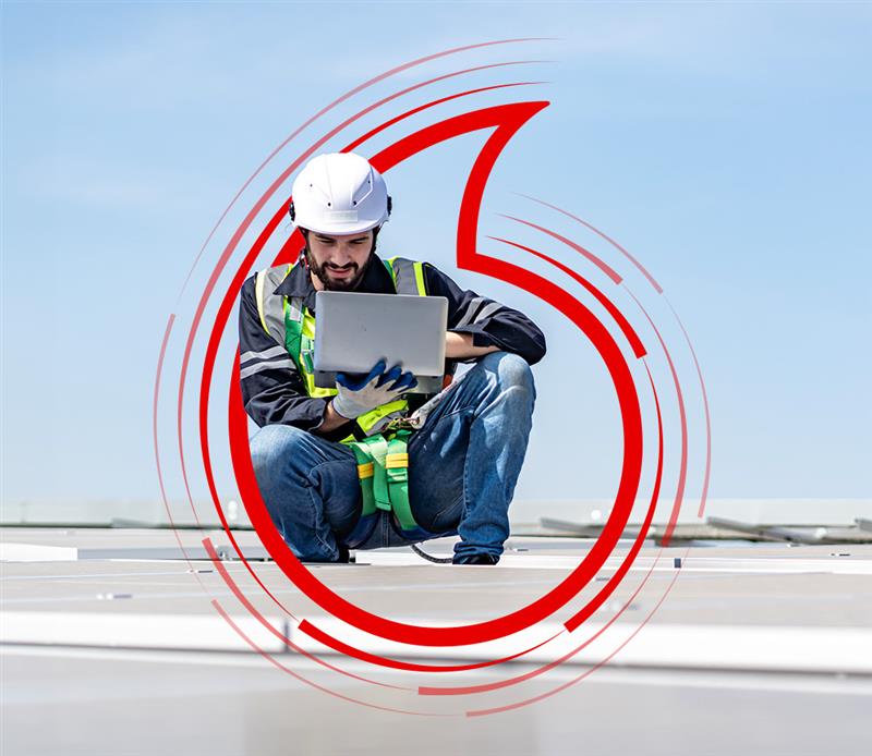 Worker in a hard hat using a tablet, surrounded by a Vodafone graphic in a TPG promotional image