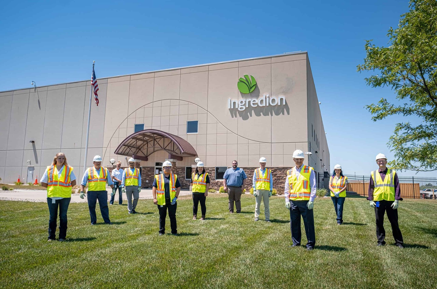 A group wearing safety vests outside an Ingredion facility