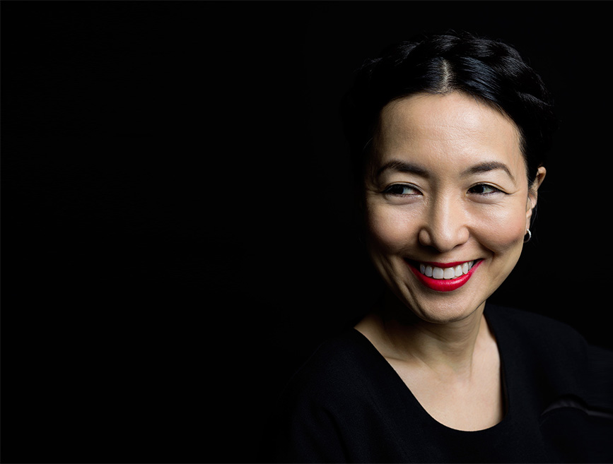 Tracy Saunders smiling against a dark background