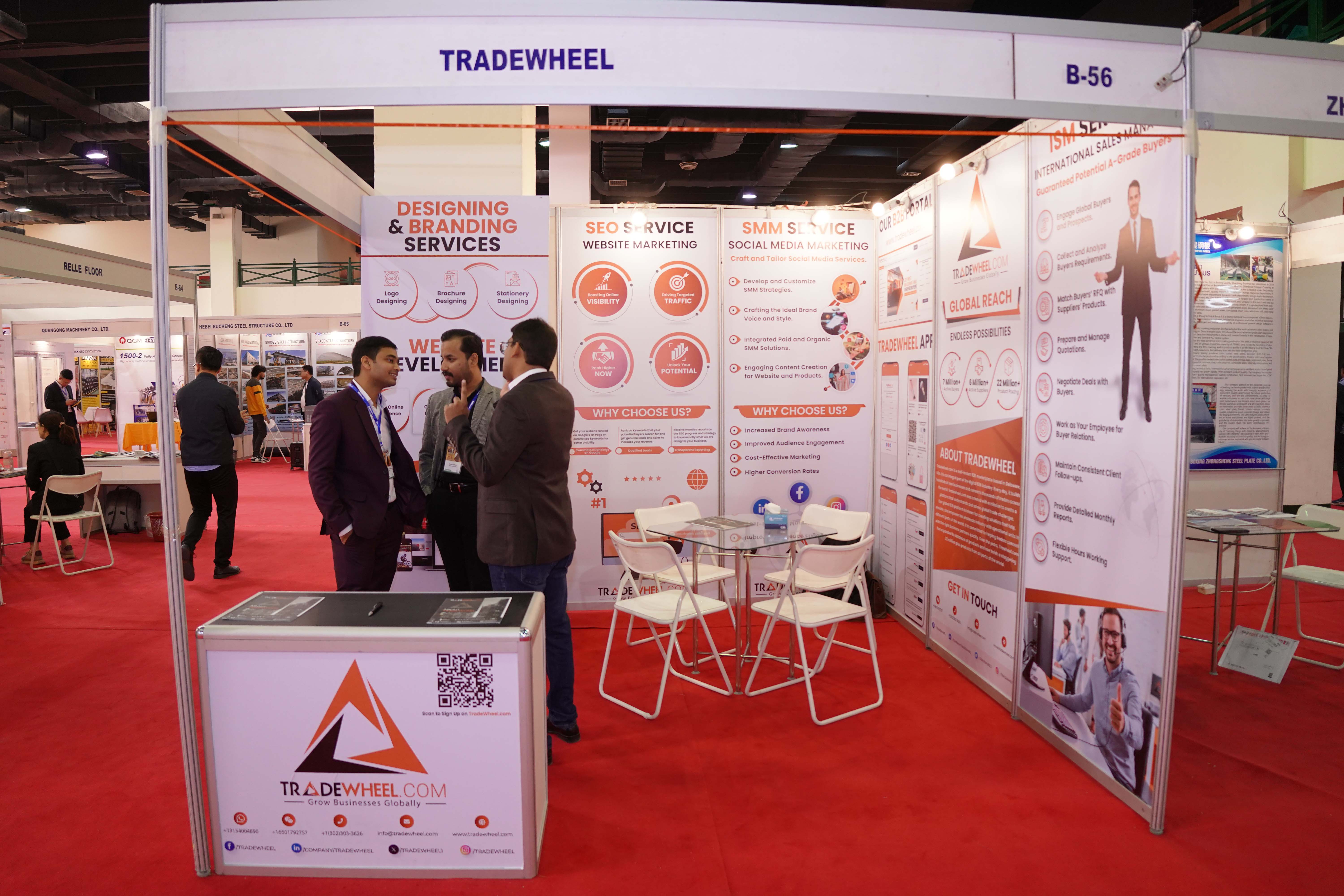 TradeWheel representatives talking at its Build Asia exhibition booth