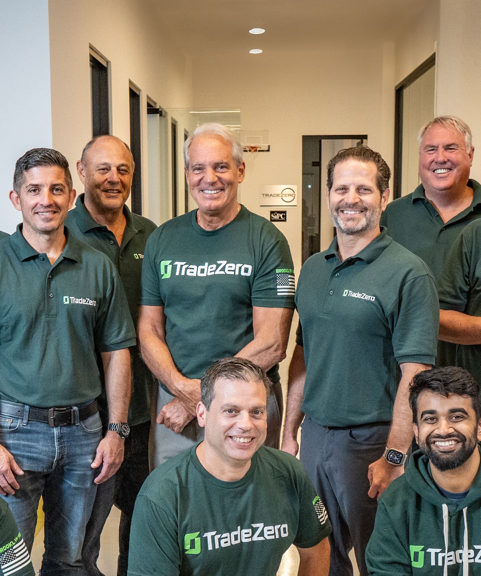 TradeZero team members gathered together in an office hallway