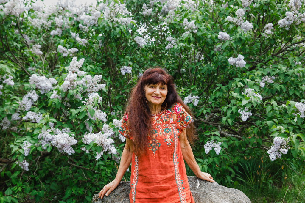Rosemary Gladstar standing among flowering plants