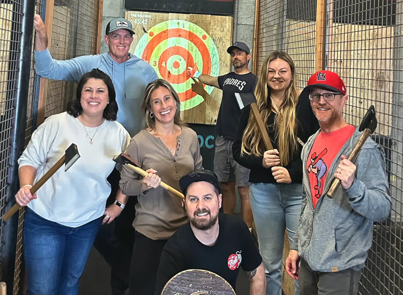 Traina colleagues posing at an axe-throwing outing