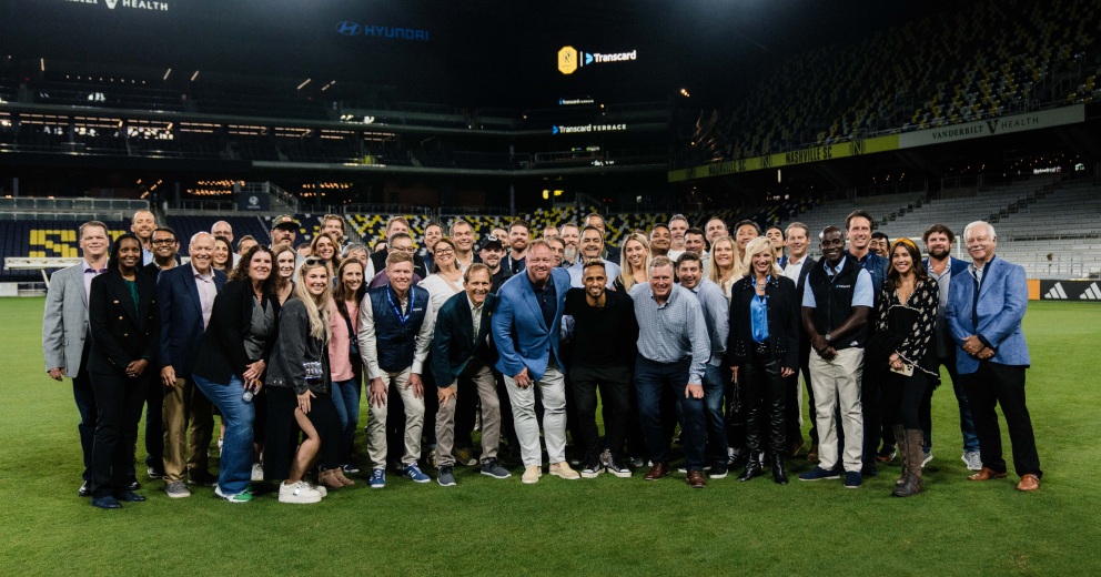 Group gathered on the pitch at Transcard’s GEODIS Park event
