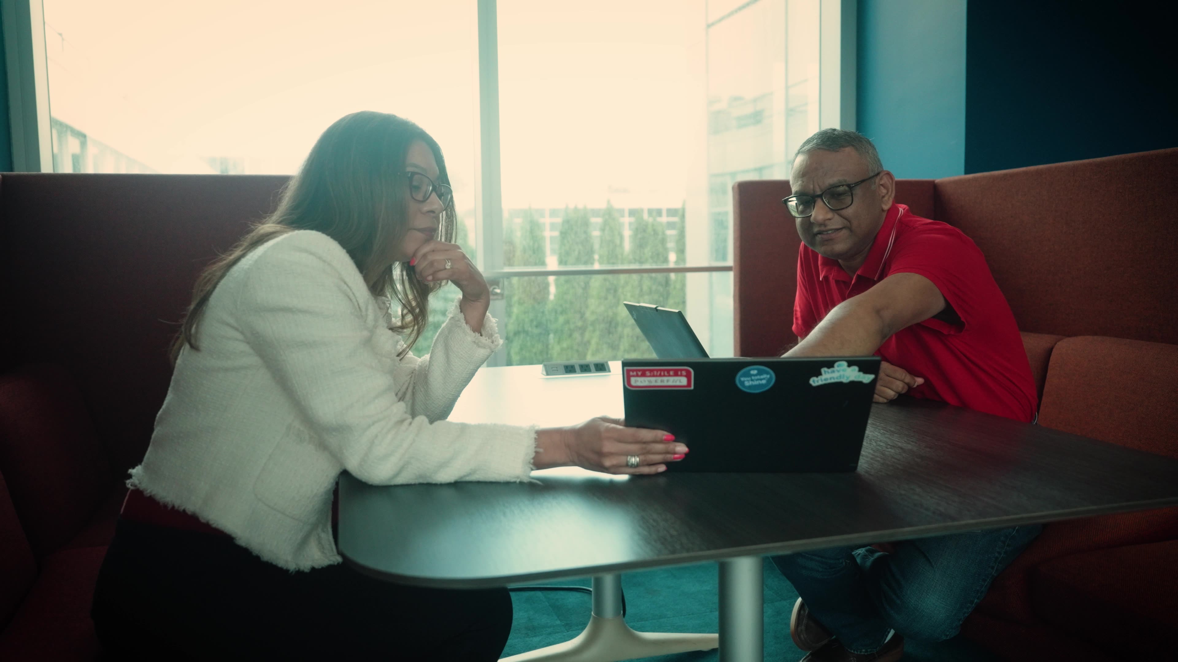 Colgate-Palmolive employees reviewing a laptop together