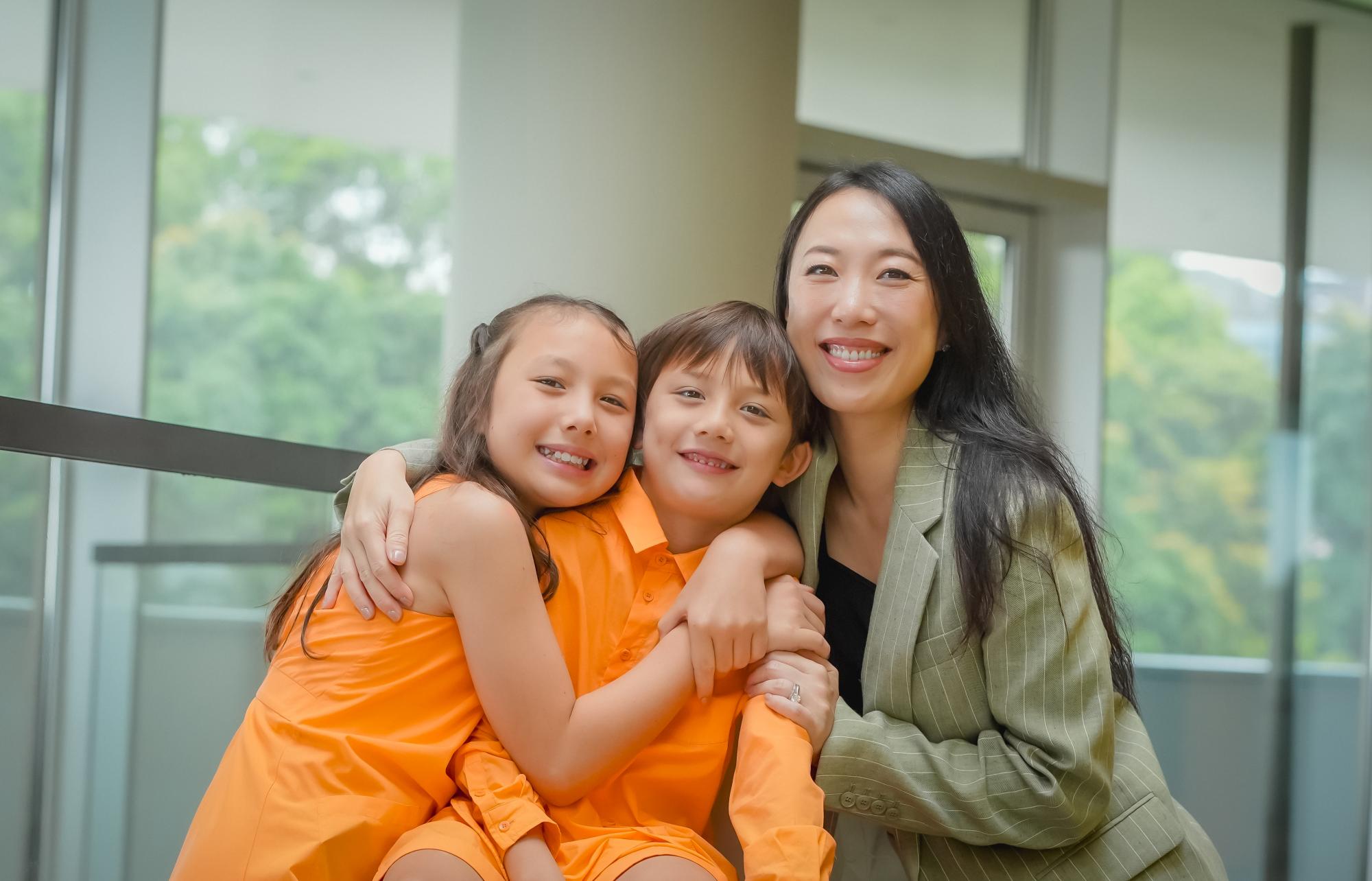 Trasy Lou Walsh smiling with two of her children