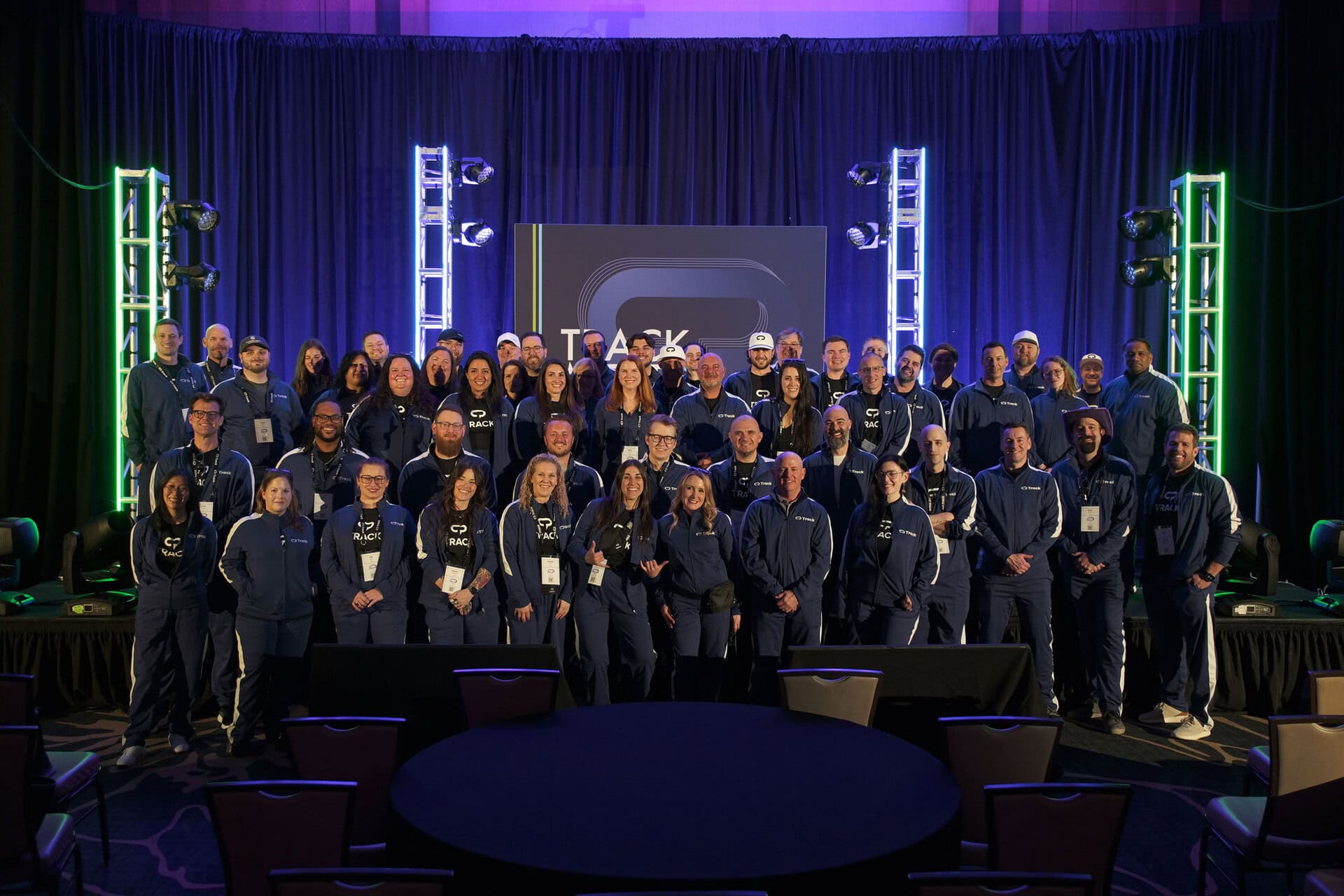 Track employees gathered on stage at TrackMeet26