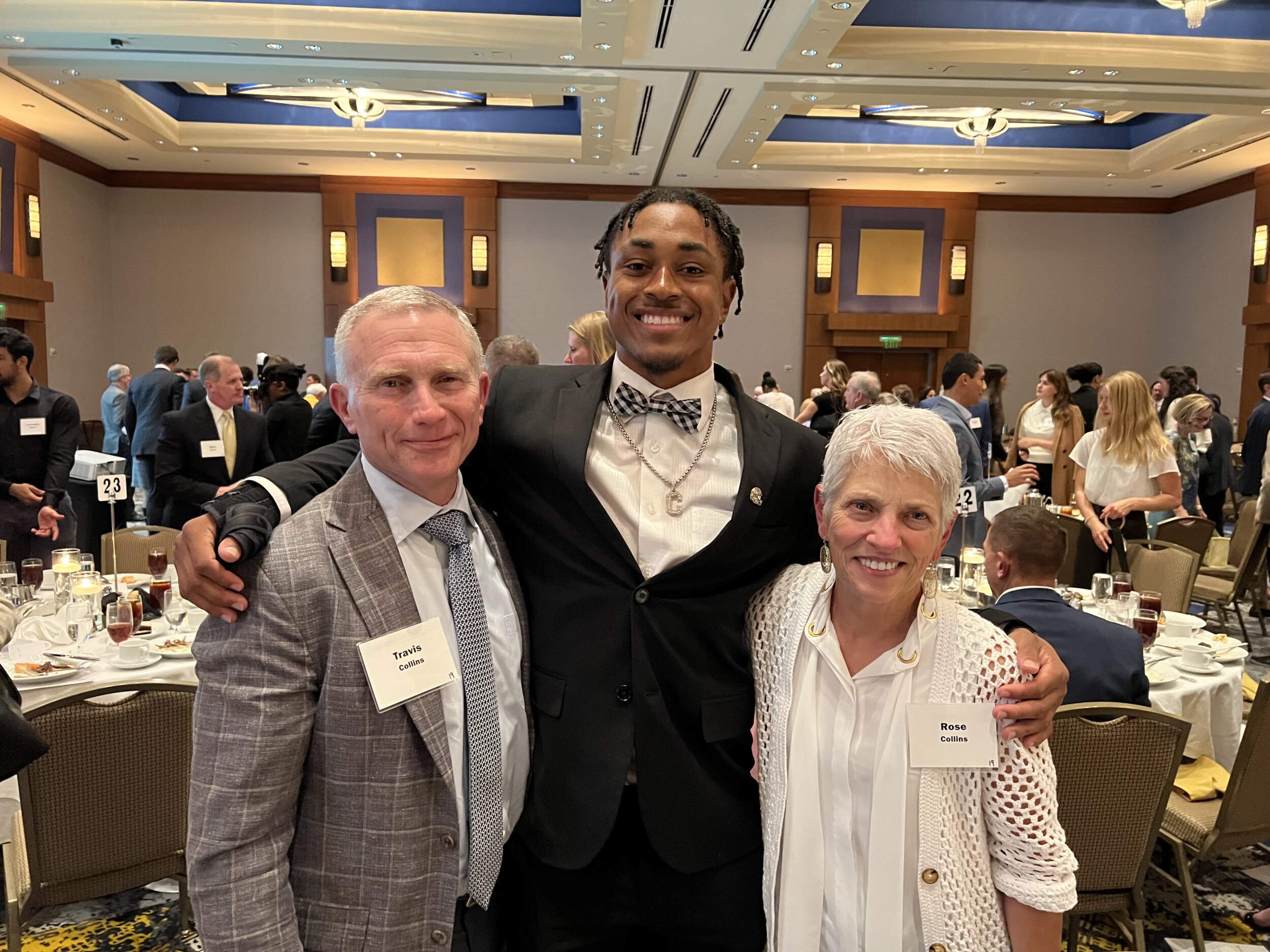 Travis Collins at left and Rose Collins at right with a guest at a Georgia Tech gathering