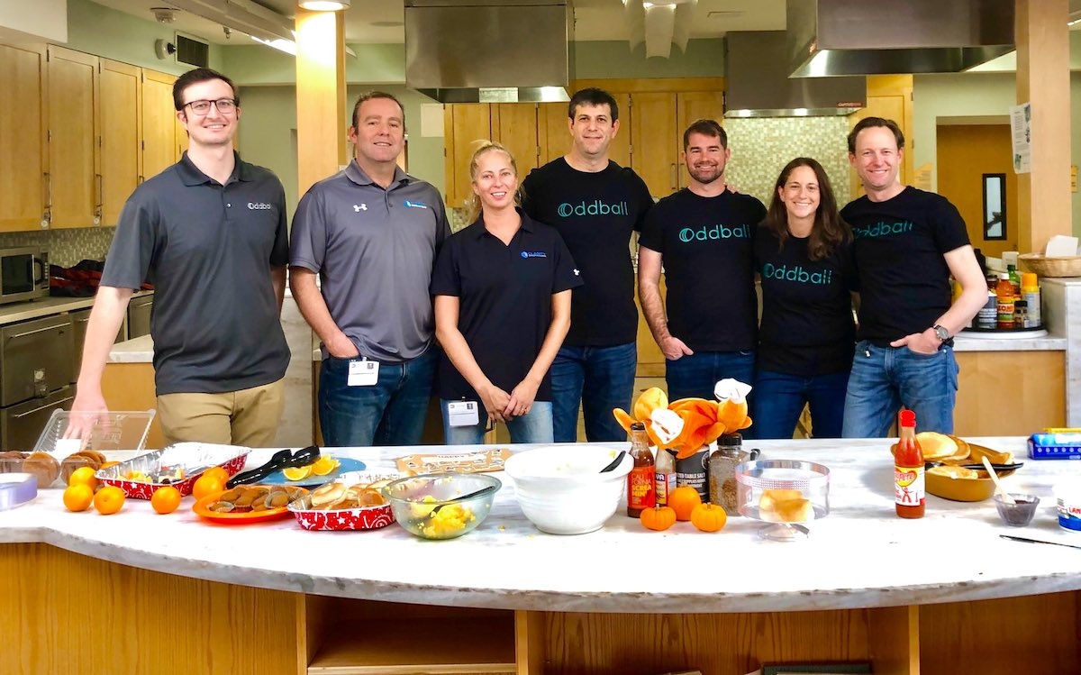 Travis Sorensen, third from right, with colleagues gathered in a kitchen