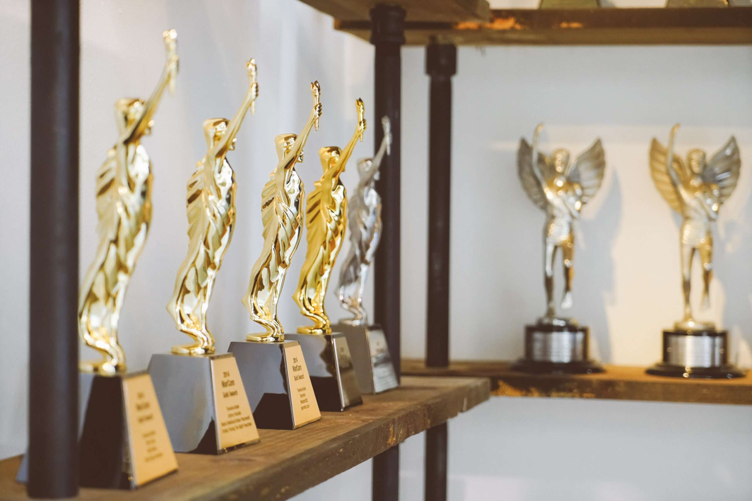 Gold and silver awards displayed on shelves in the Trevelino Keller office