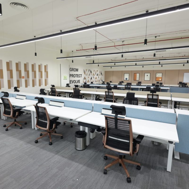 Rows of desks and monitors in an open work area at Trexquant’s India office