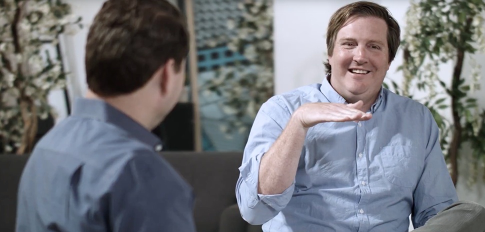 Trey Bowles, at right, smiling during a seated conversation with Glen Collins
