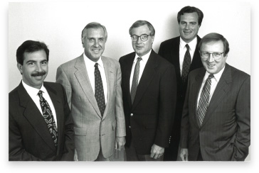 Trident’s four co-founders and adviser Ed Mathias standing together in 1993