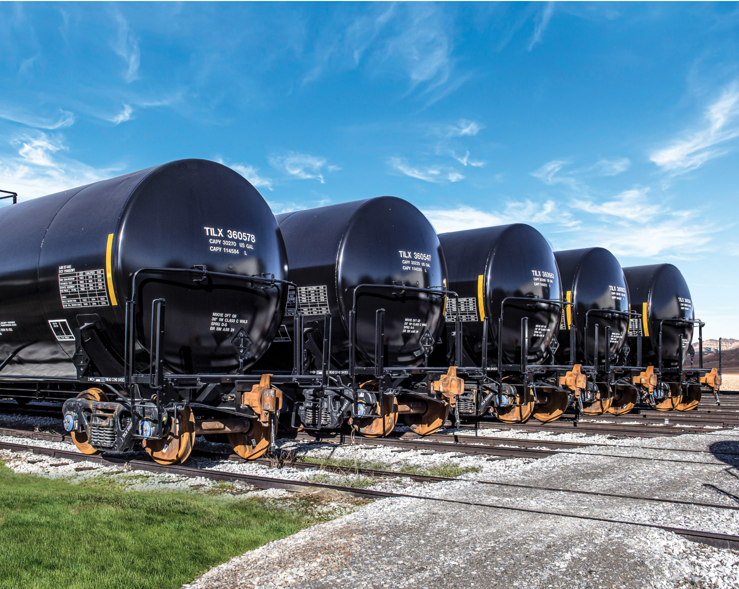 Black TrinityRail tank cars lined up on parallel tracks