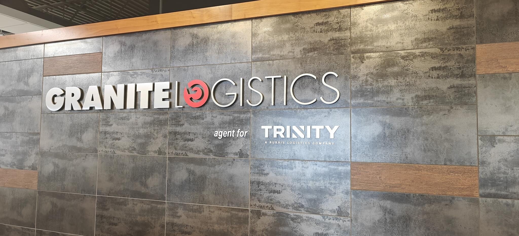 Granite Logistics office wall with signs identifying its former role as an agent for Trinity