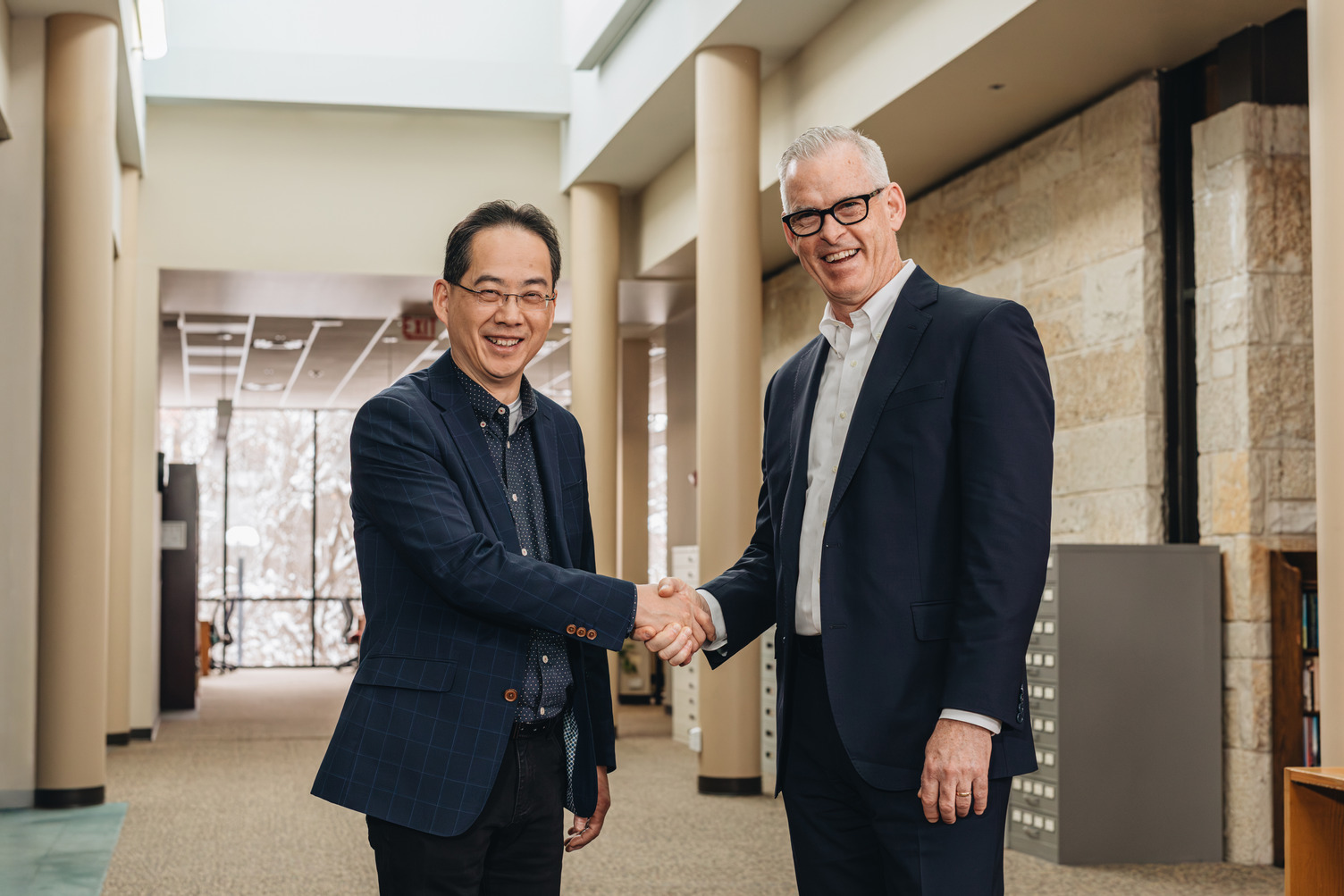 TEDS dean David Pao and TWU president Todd Martin shake hands