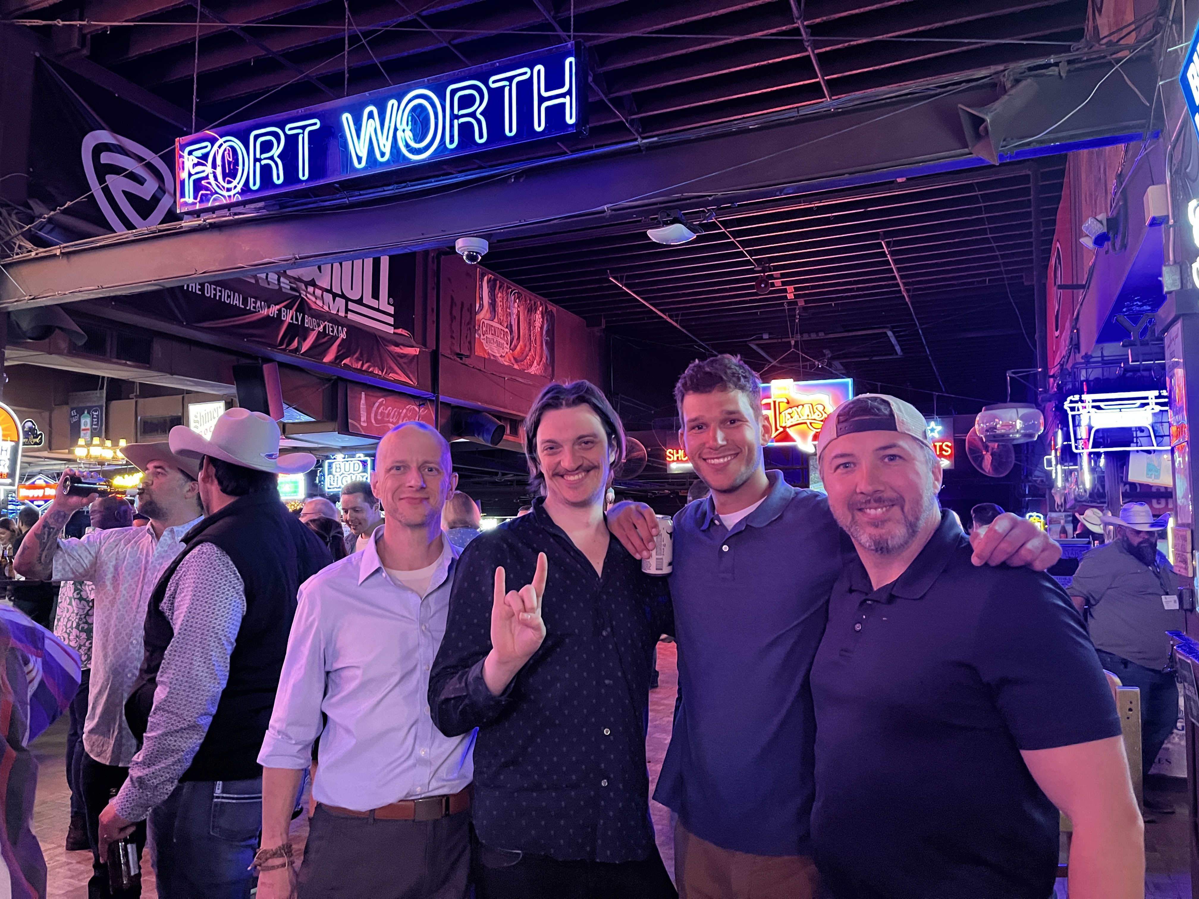 Four Trinnex colleagues posing together at Billy Bob’s Texas