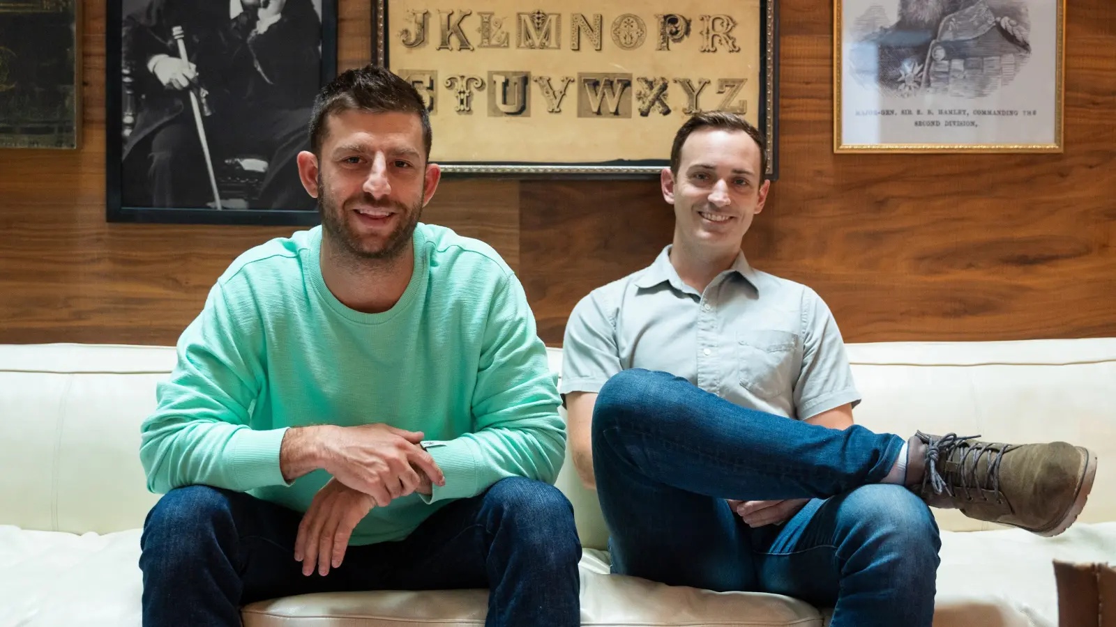 Troy Sultan and Austin Cooley seated together on a white sofa