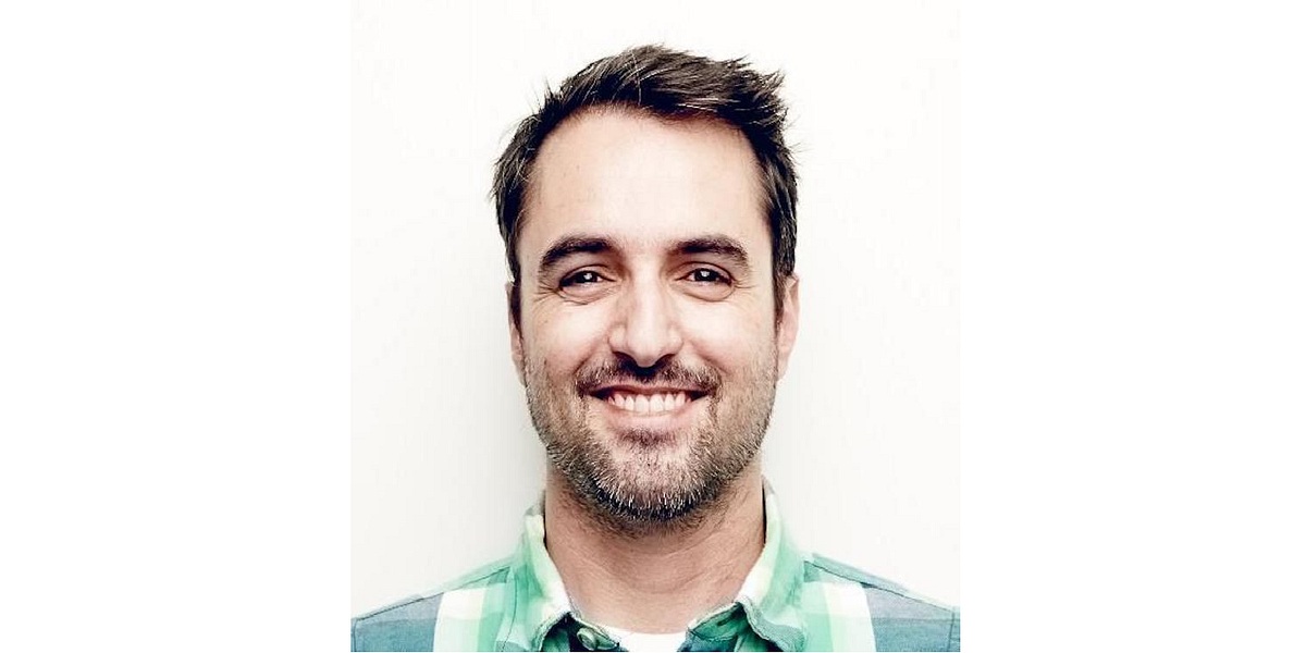TrueAccord co-founder Ohad Samet smiling in a green checked shirt