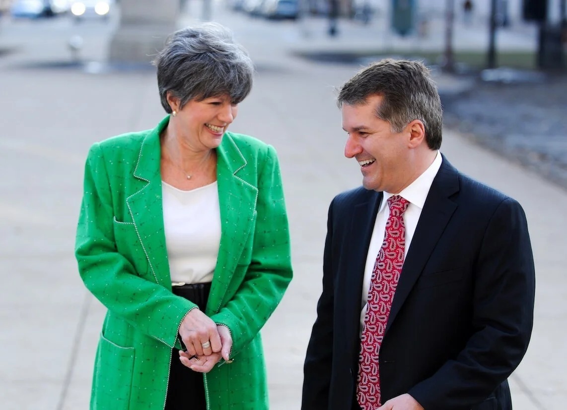 Kelly Rossman-McKinney and John Truscott laughing together outdoors