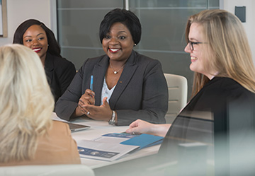 Trustmark associates seated around a table in conversation