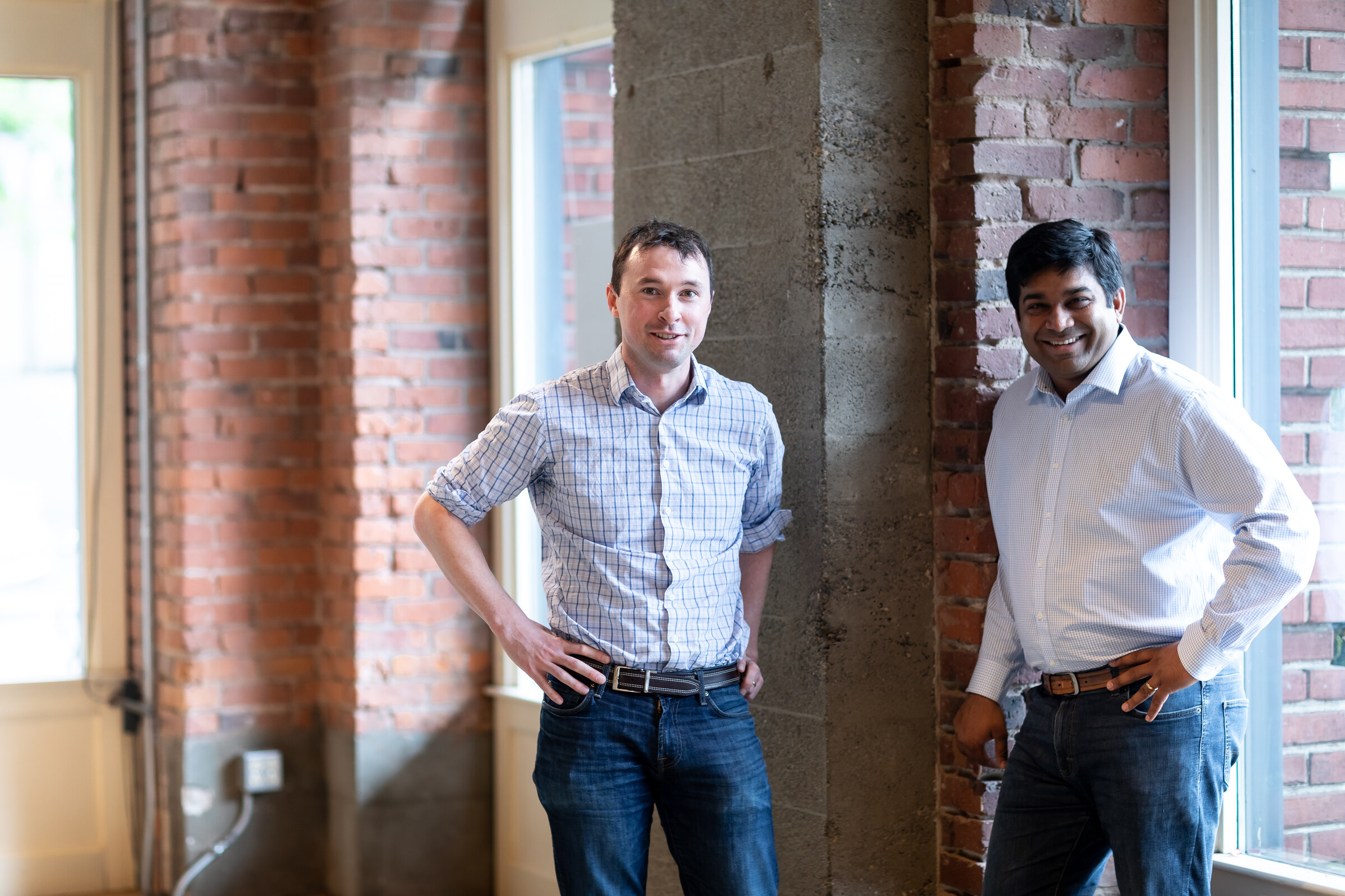 Flyhomes founders Stephen Lane and Tushar Garg standing in a Seattle office
