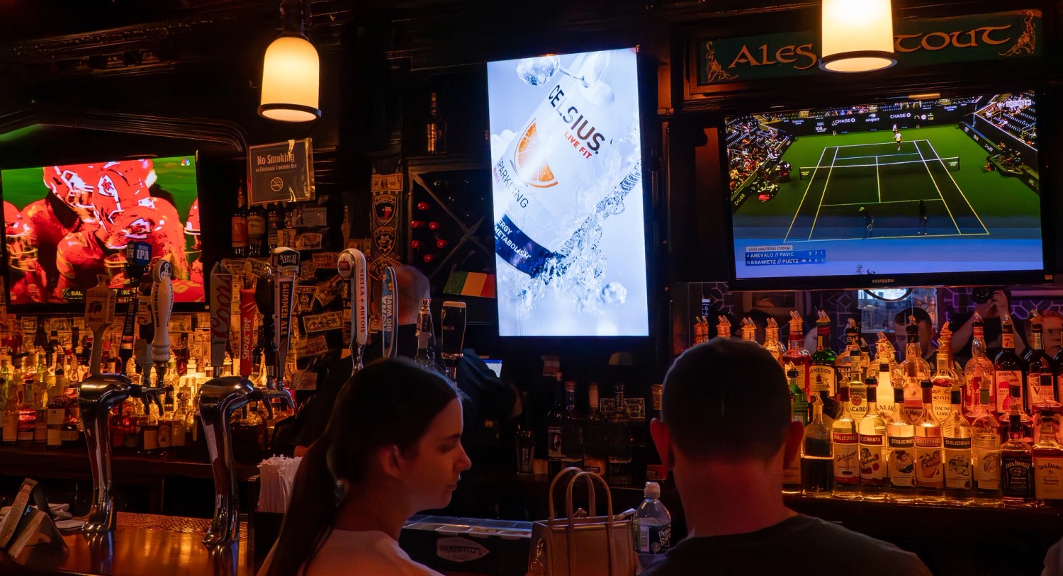 A Celsius advertisement on a vertical display inside a hospitality venue