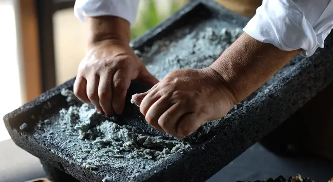 Hands preparing food on a stone surface in Twelve12’s Nómada portfolio