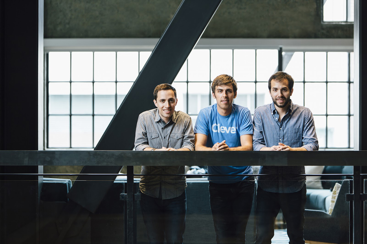 Clever co-founders Tyler Bosmeny, Dan Carroll and Rafael Garcia leaning on a railing in their San Francisco office