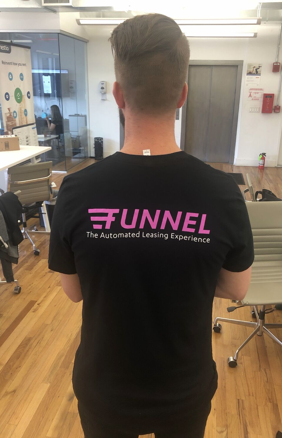 Tyler Christiansen wearing the first Funnel branded shirt in a Manhattan office in 2019