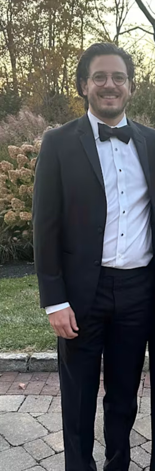 Tyler Fallon in a black tuxedo, standing outdoors