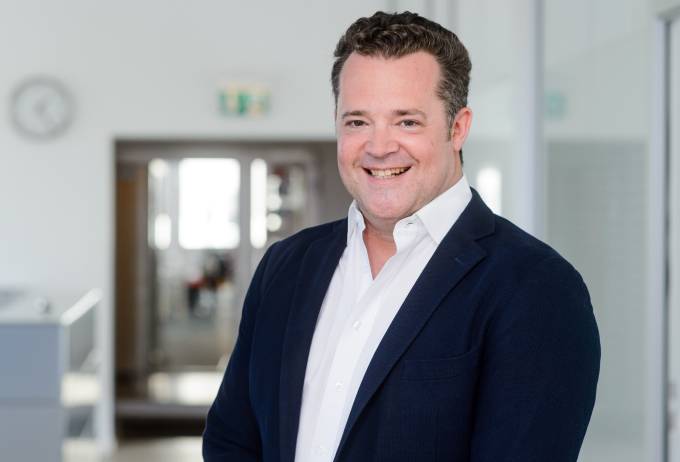 Tyntec co-founder and CTO Thorsten Trapp standing in an office
